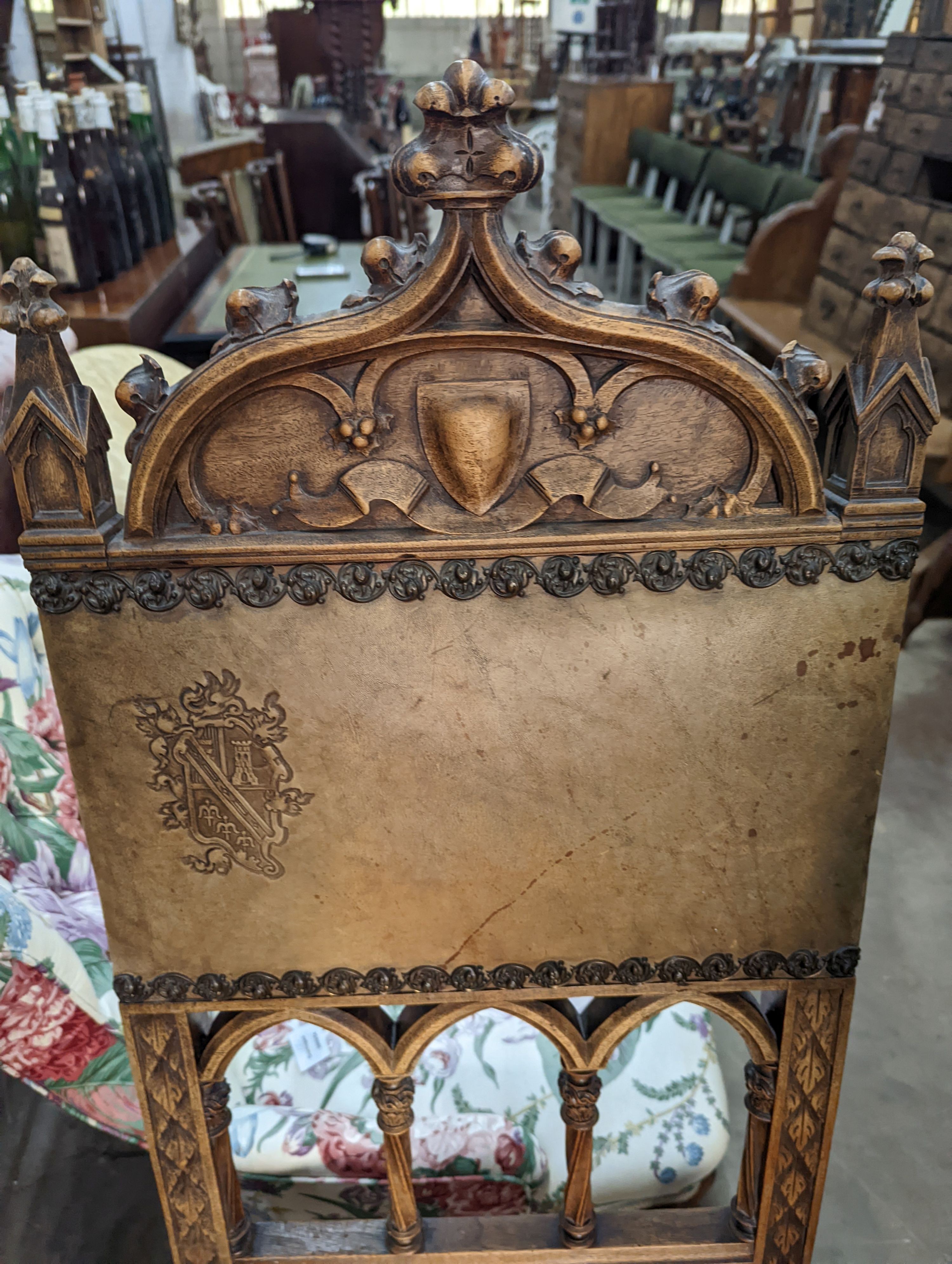 A pair of Gothic style carved walnut and leather side chairs together with an Edwardian beech folding chair